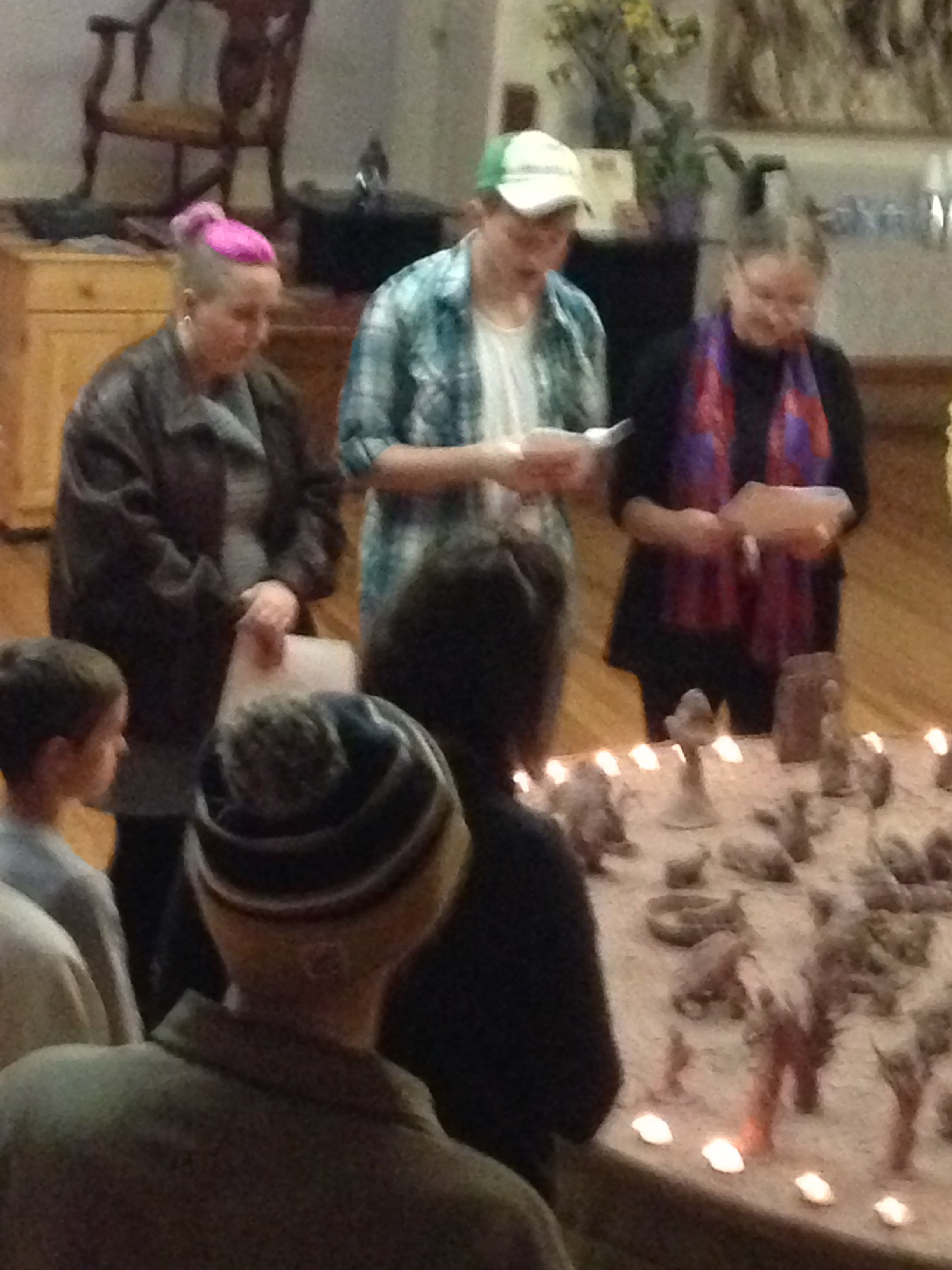 People gathered around candlelit ceremonial table