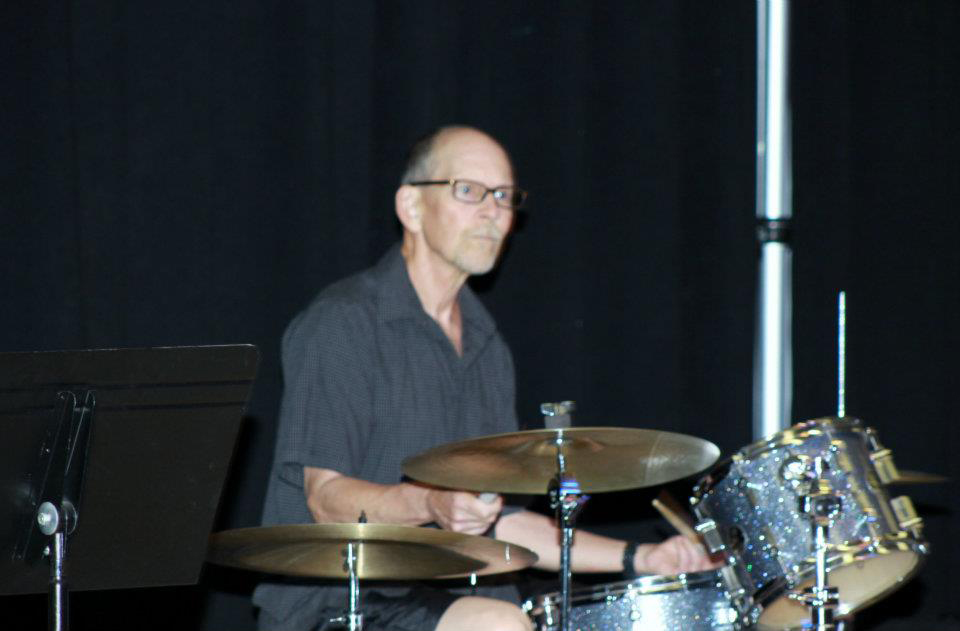 Man playing drum set on stage