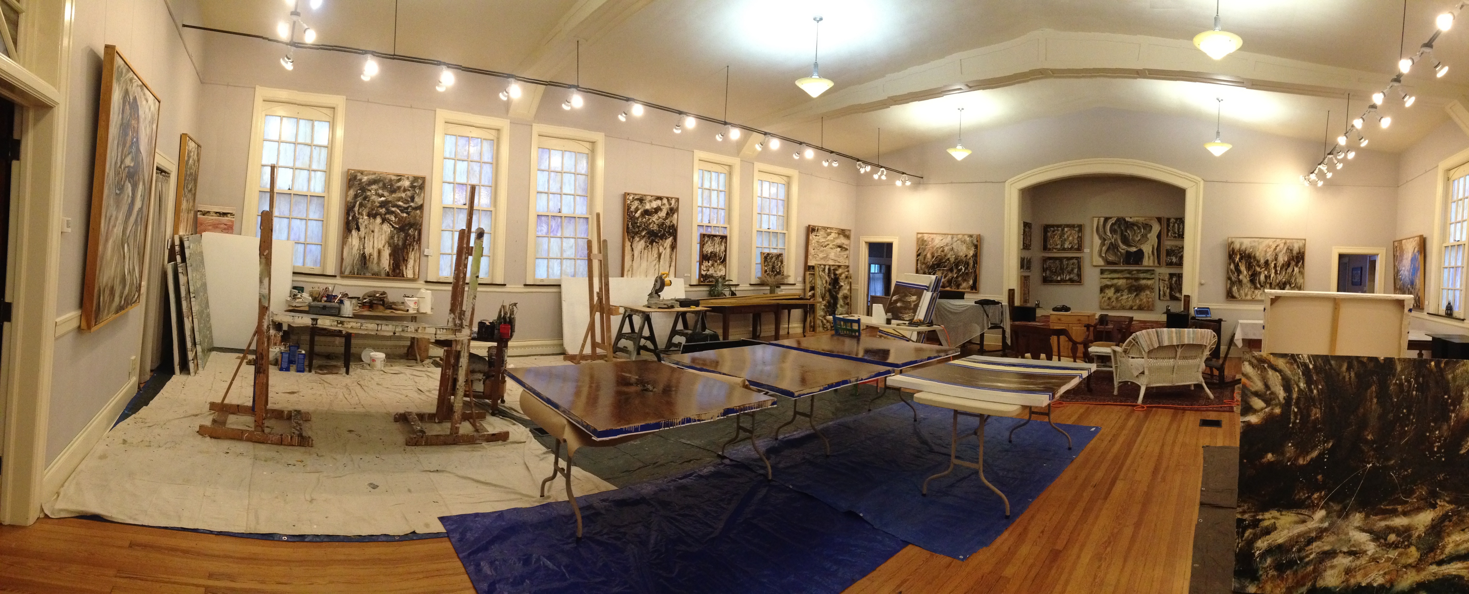 Spacious art studio with easels and paintings
