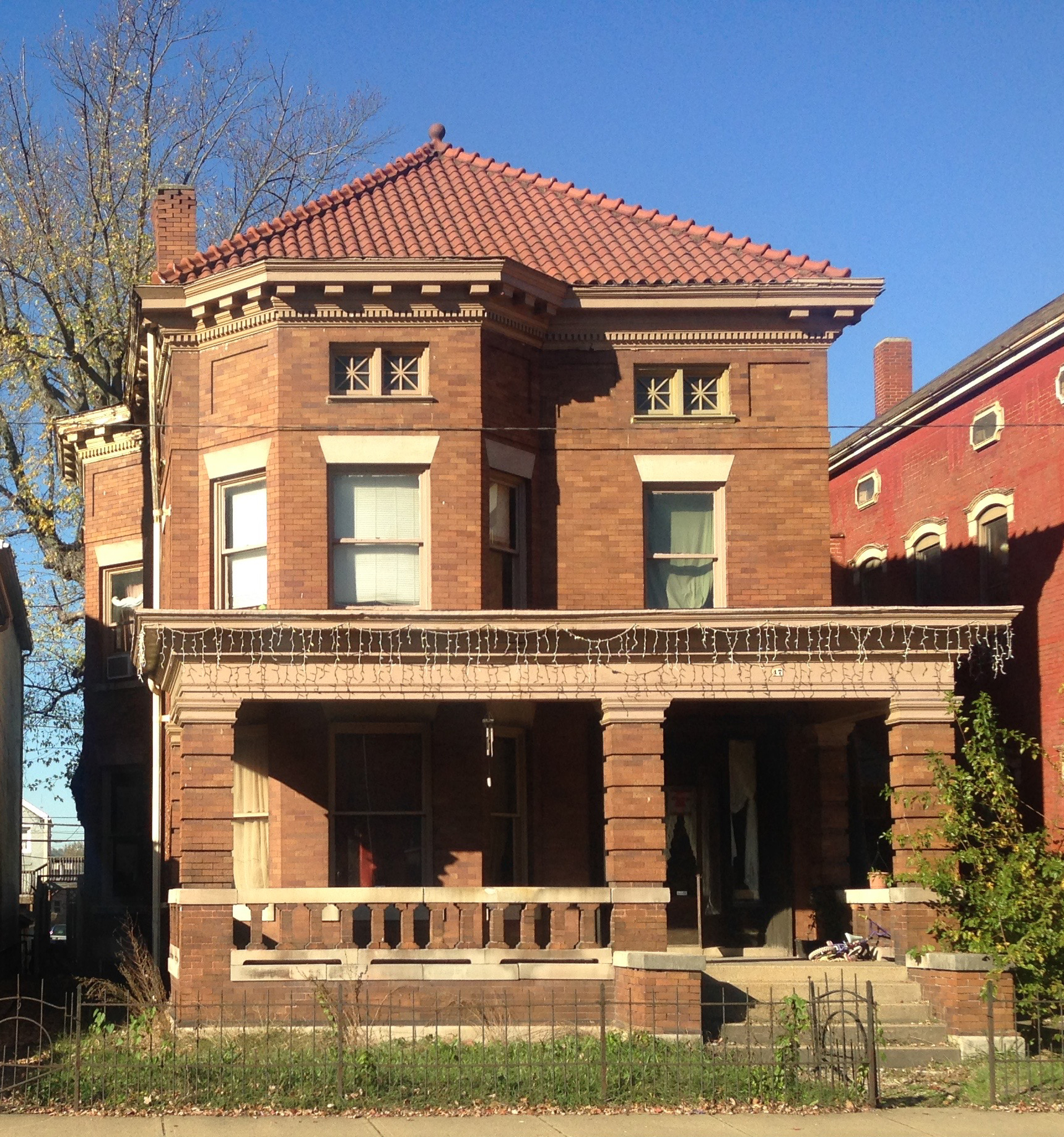 Two-story red brick house with porch