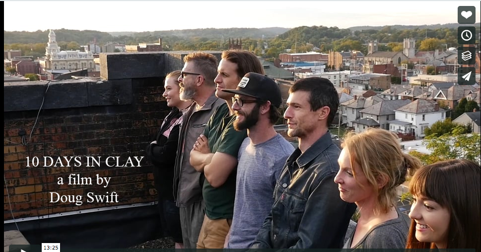 Group of people on rooftop overlooking town