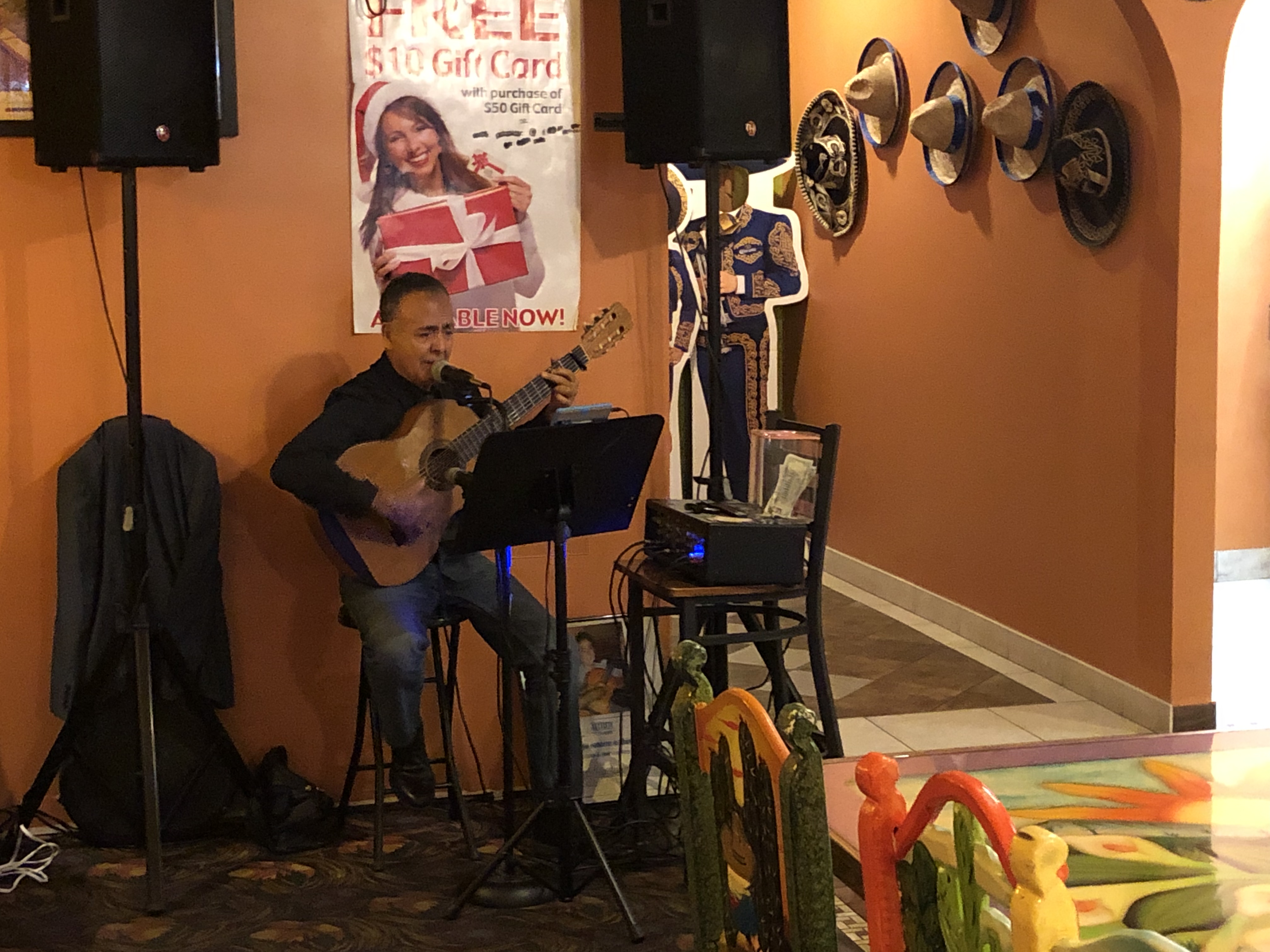 Man playing acoustic guitar in restaurant