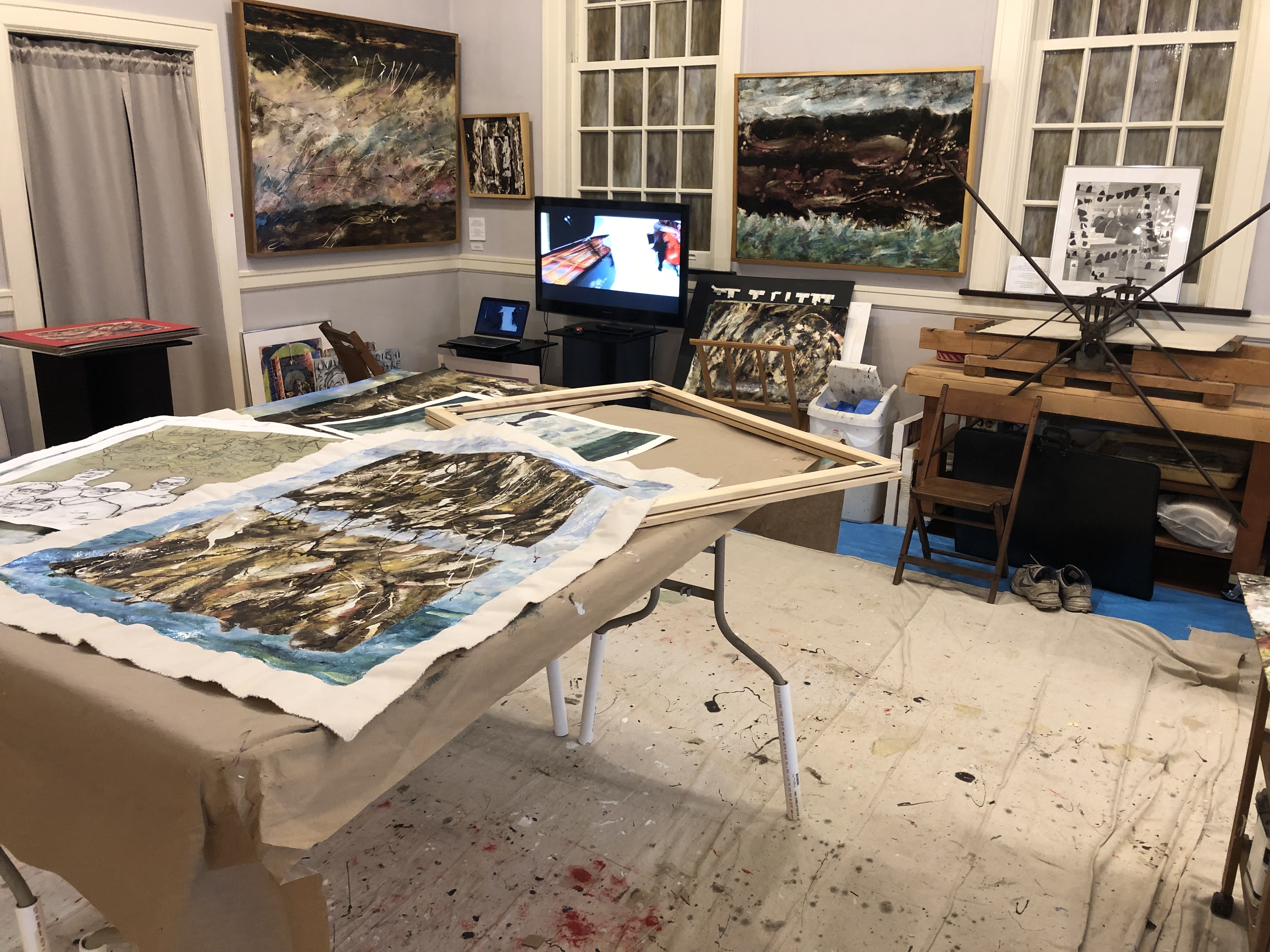 Artist's studio with paintings and prints