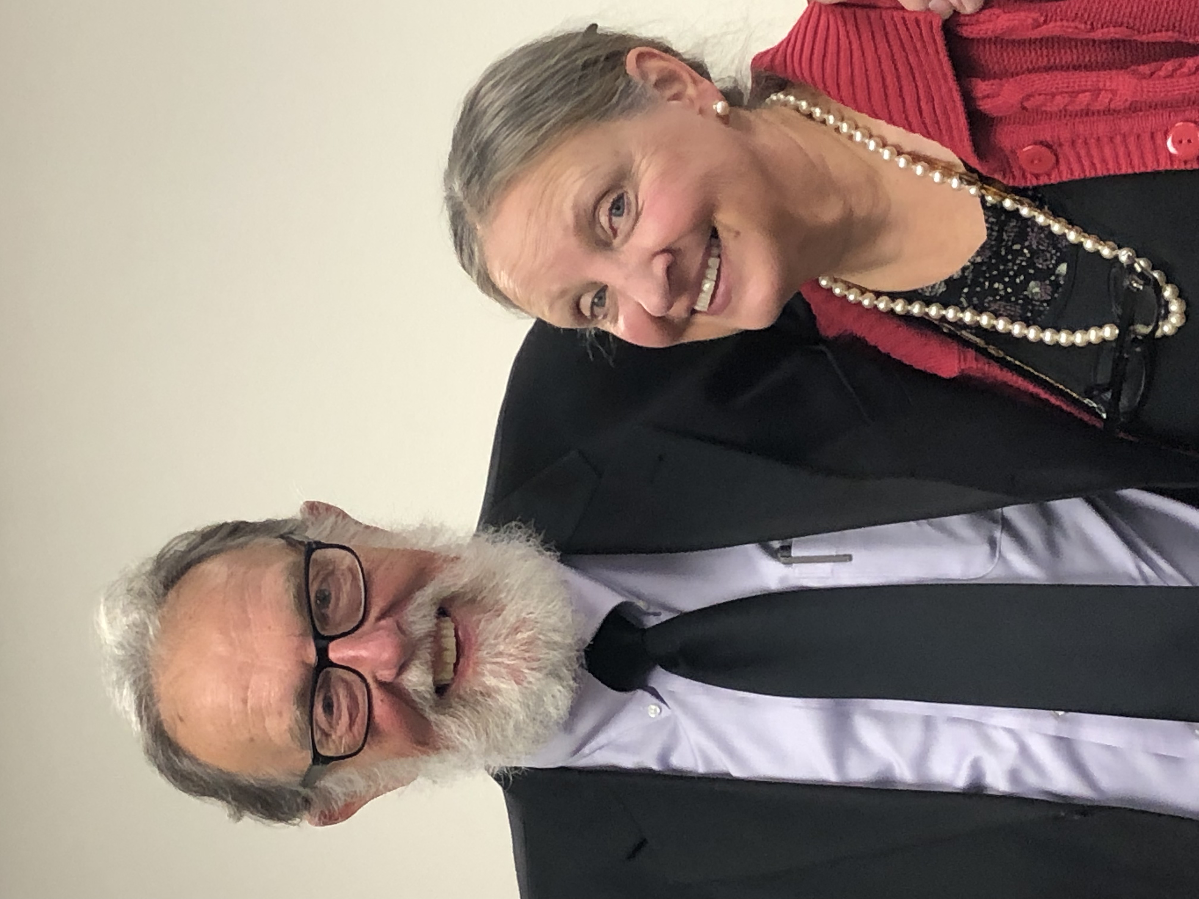 Smiling older couple dressed in formal attire