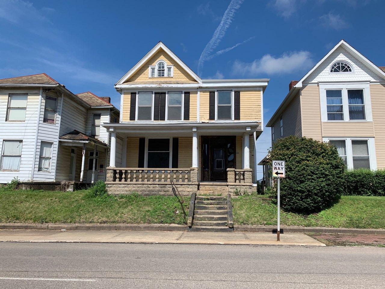 Yellow two-story house with front porch