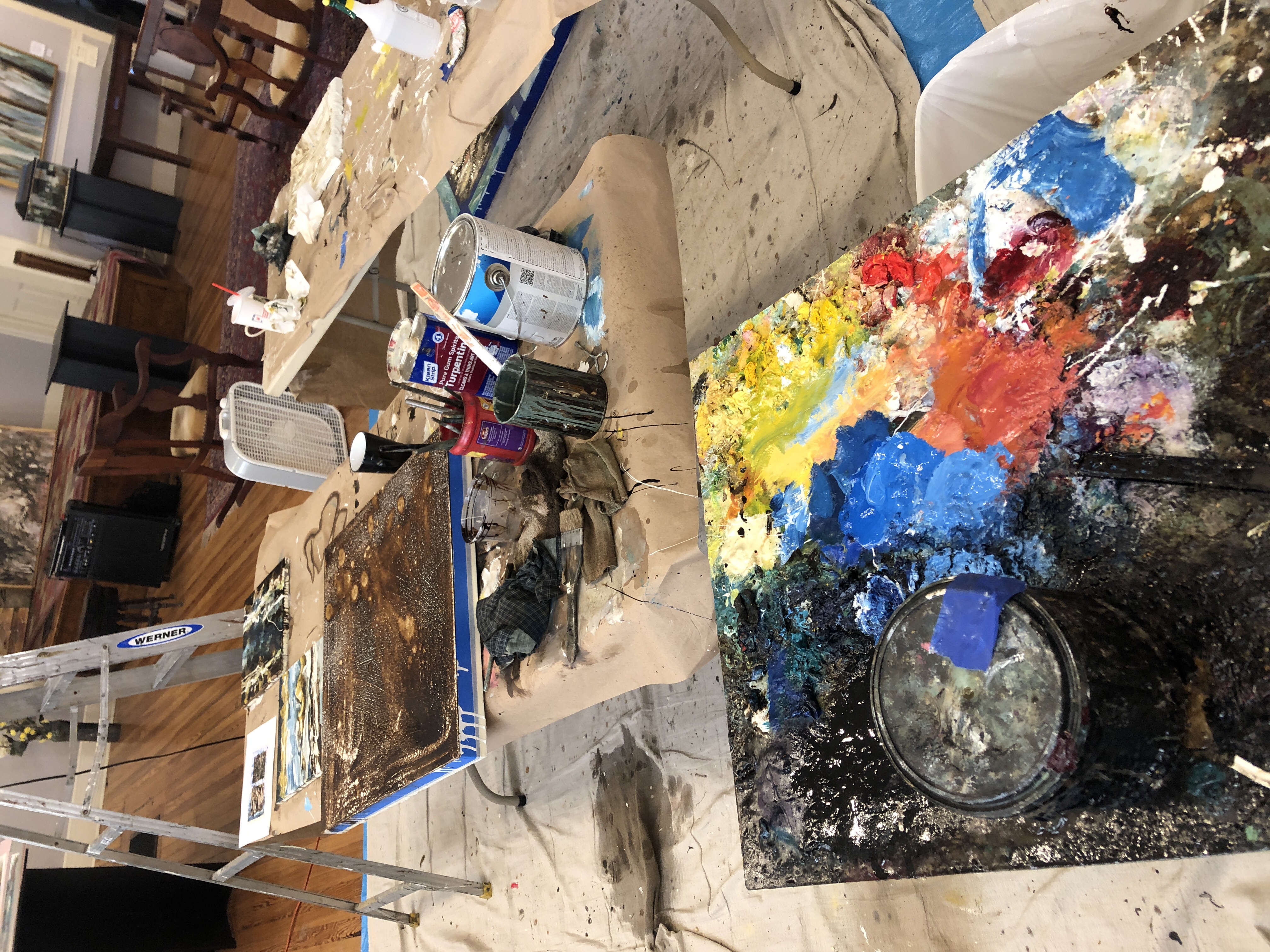 Artist studio table with paint-splattered palette