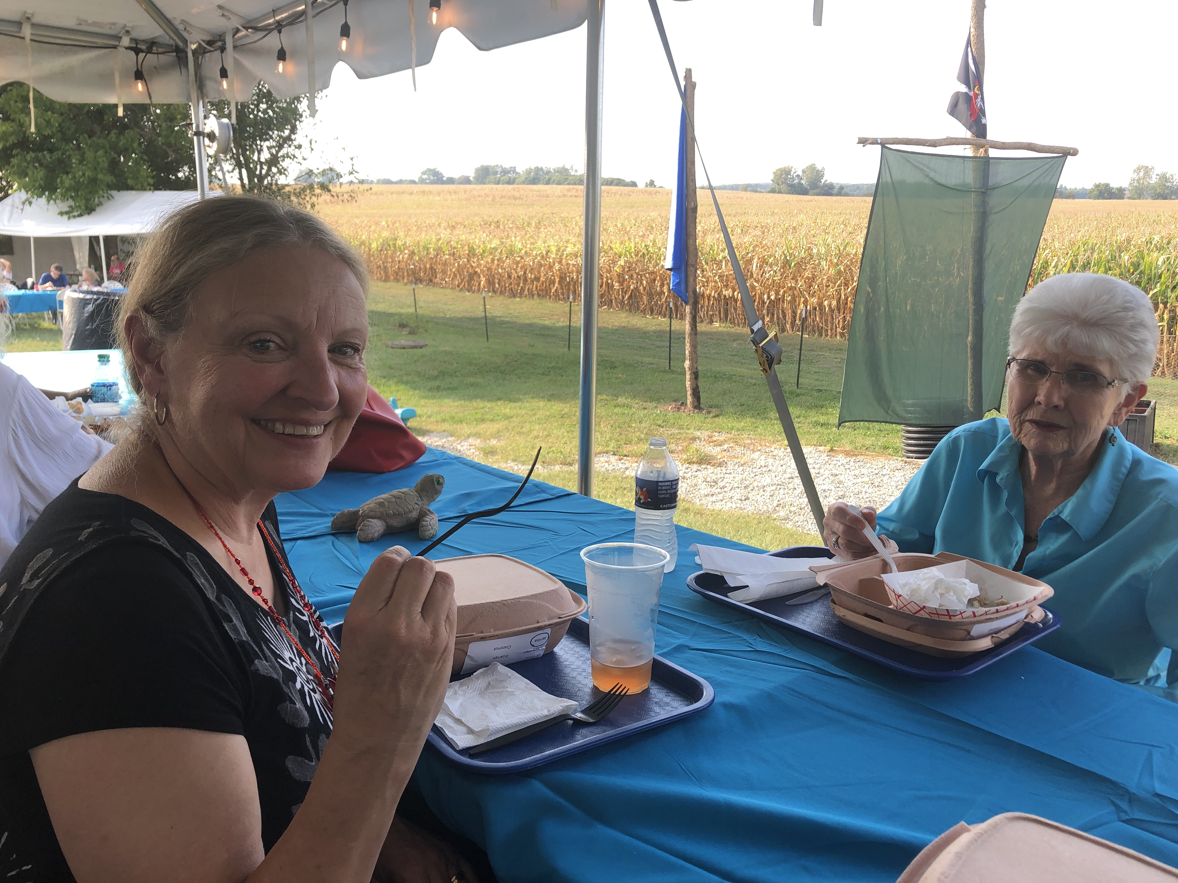 Two women eating at outdoor picnic table