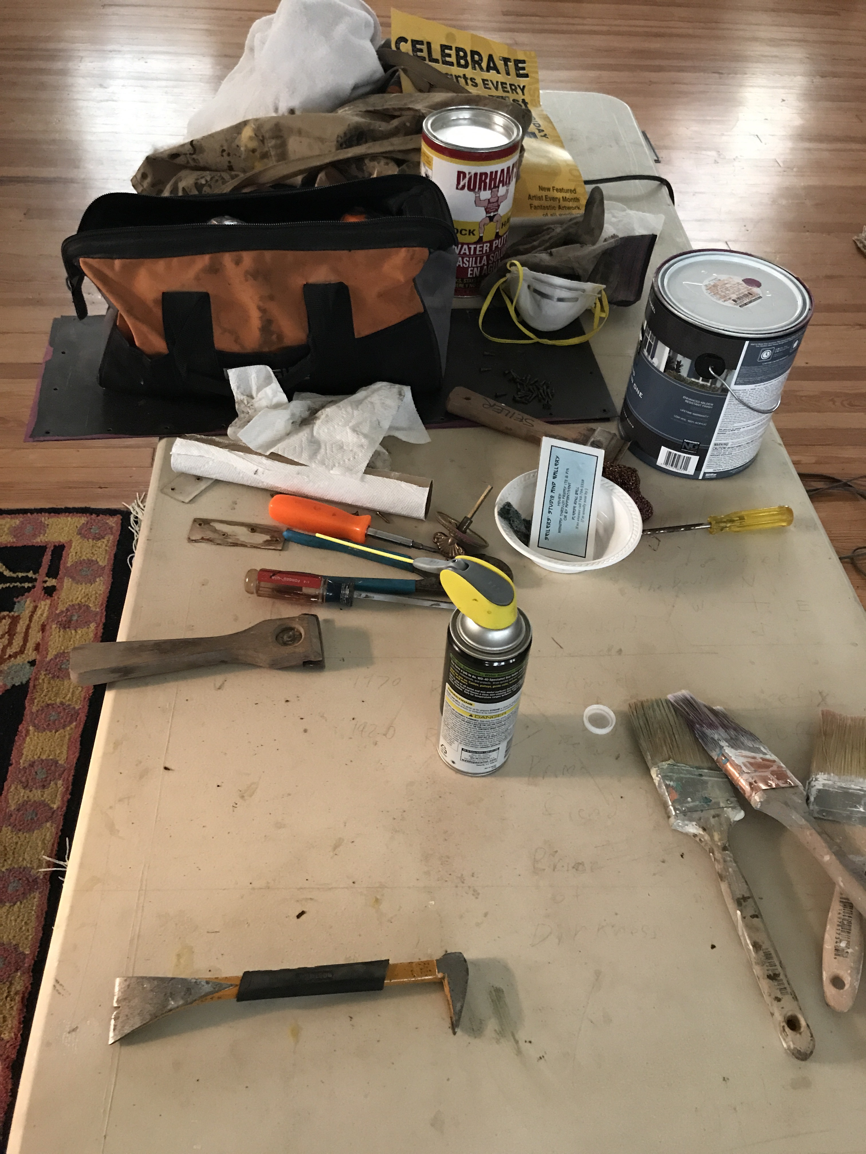 Assorted painting and repair tools on table