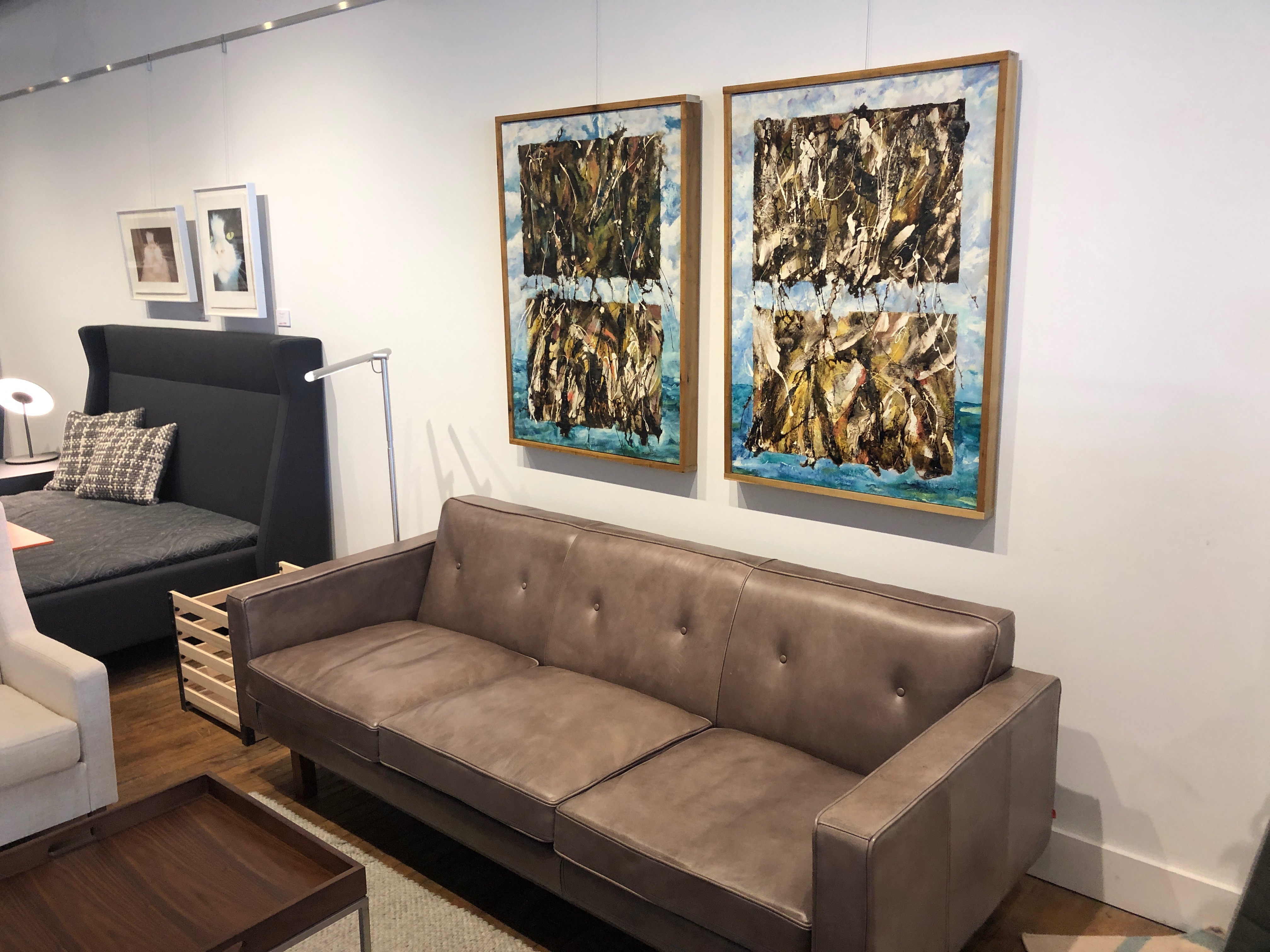 Modern brown leather sofa with abstract paintings