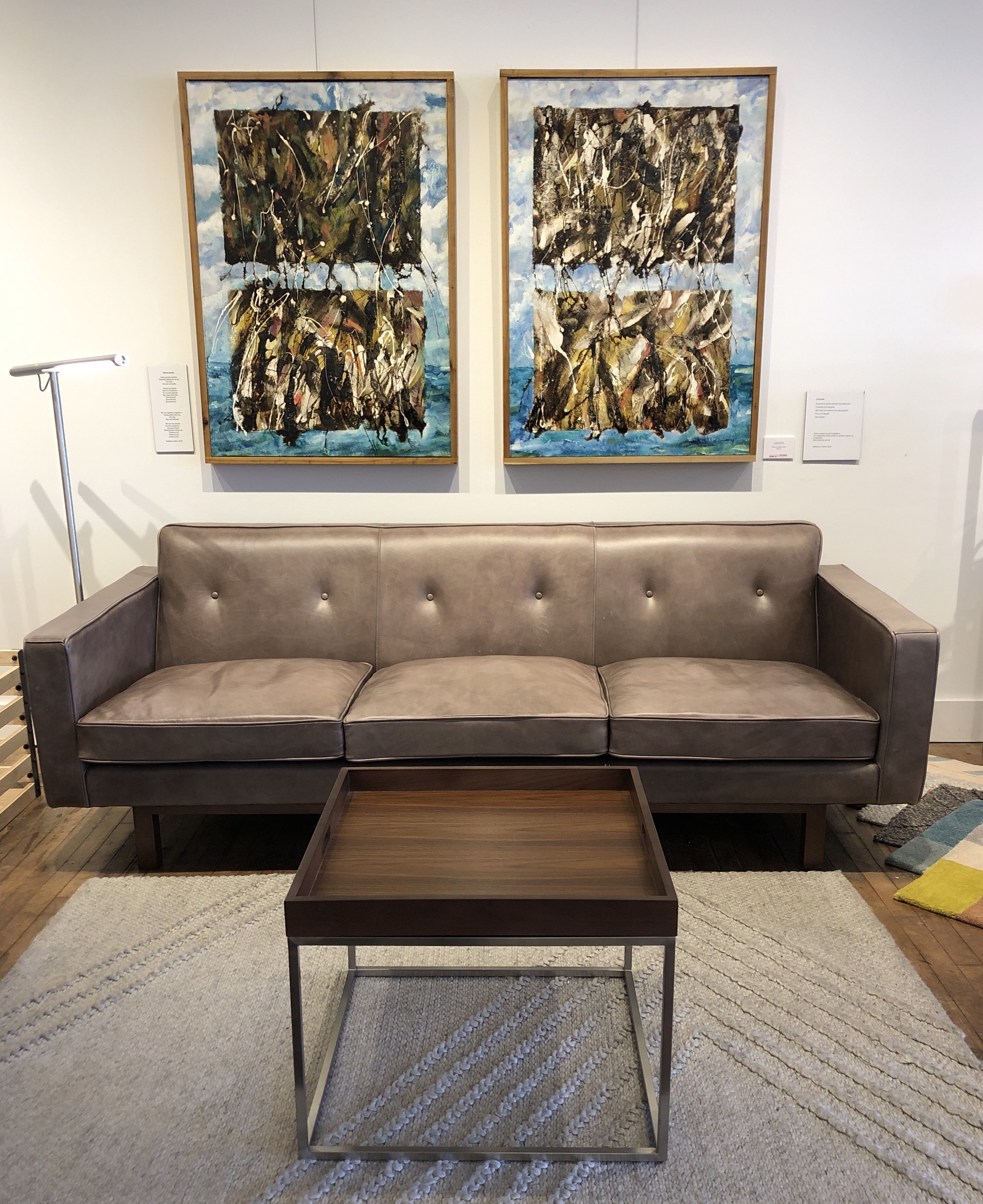 Gray sofa with coffee table and abstract paintings