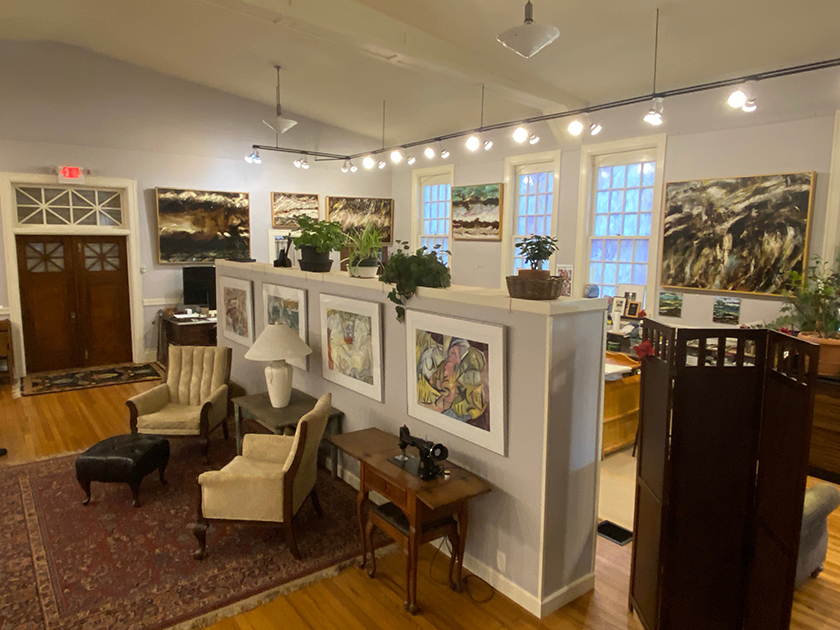 Art gallery interior with seating and paintings